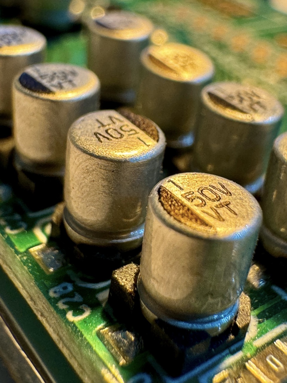 Capacitor: A cylindrical or rectangular electronic component with two leads, used to store and release electrical energy in circuits, commonly found in power supplies and filtering applications.