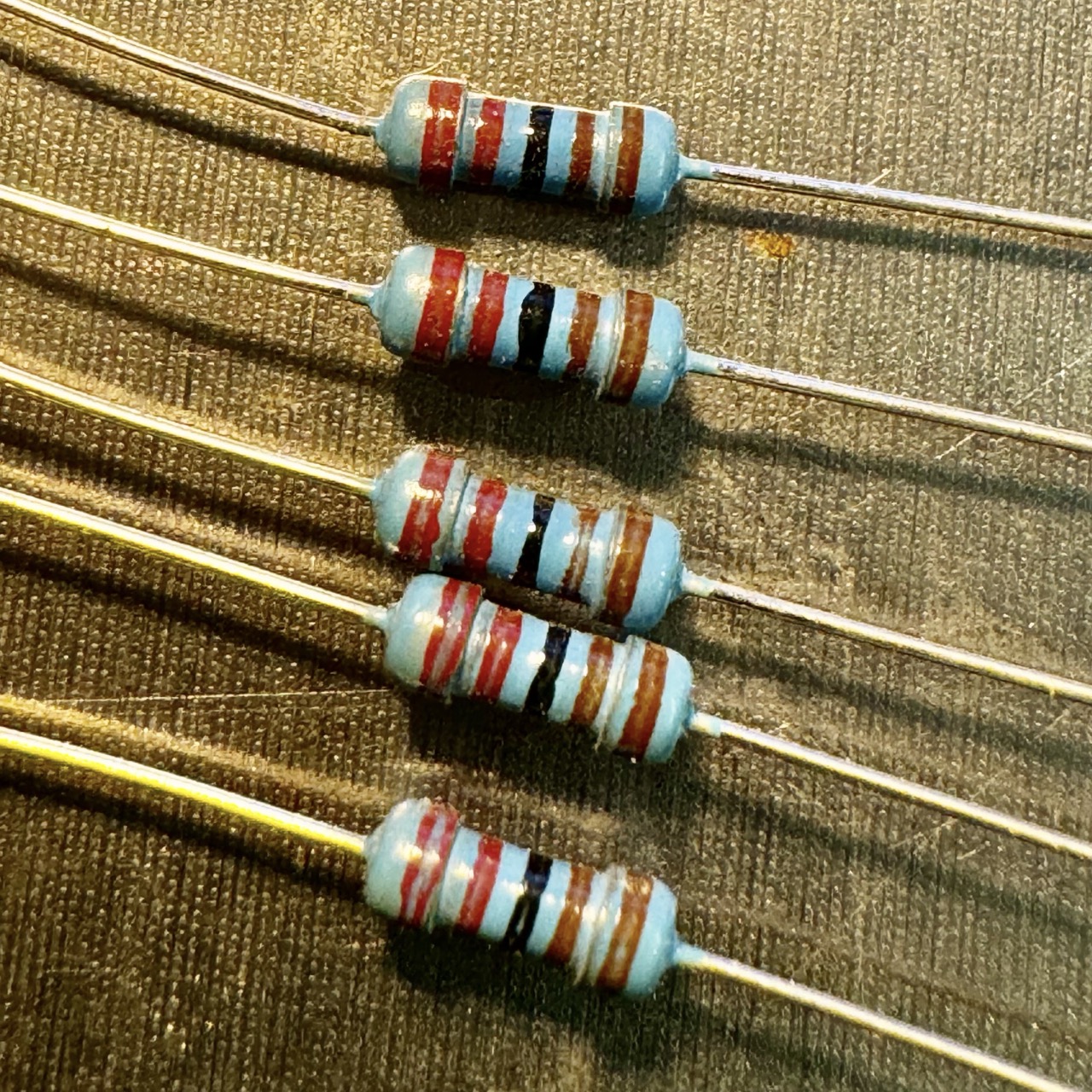 Image of four resistors with colored bands indicating their resistance values